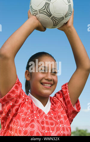 Smiling Girl Throwing in Soccer Ball Stock Photo