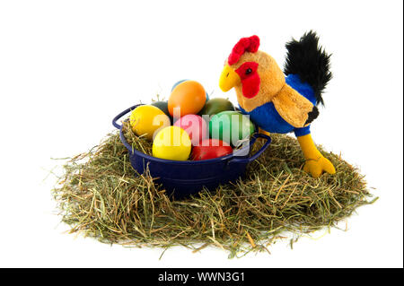 Blue bucket with straw and colorful painted easter eggs with chicken Stock Photo