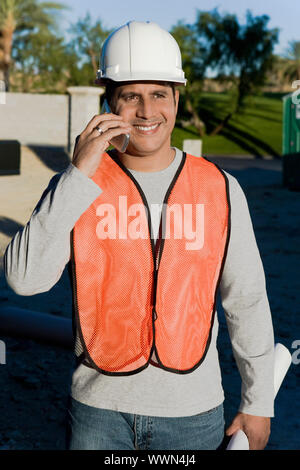 Construction Worker Using Cell Phone Stock Photo