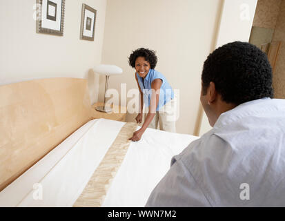 Couple Making Bed Stock Photo