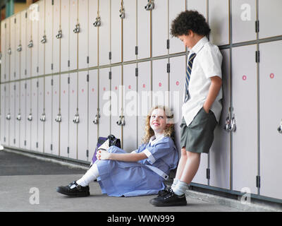 School Children Waiting Near Lockers Stock Photo