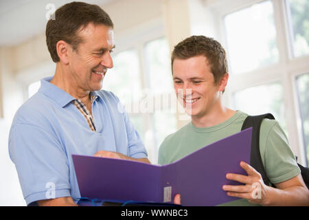 College professor providing guidance to a male student Stock Photo