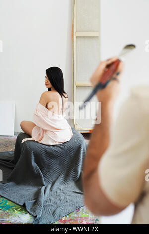 Model Posing for Painter Stock Photo