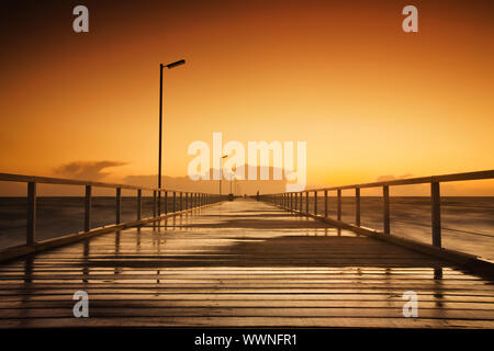 Beautiful sunset over a long jetty Stock Photo