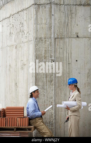 Businesspeople Looking at Blueprint Stock Photo