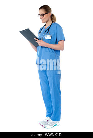 Female surgeon looking at reports isolated on white background Stock ...