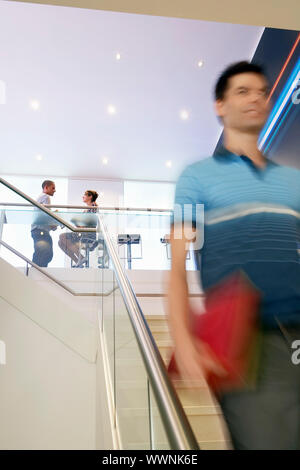 Businessman Walking Down Stairs Stock Photo