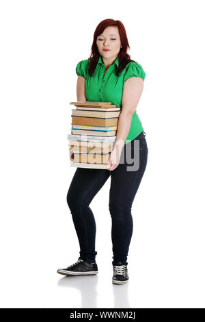 Girl schoolgirl with a heavy stack of books isolated Stock Photo - Alamy