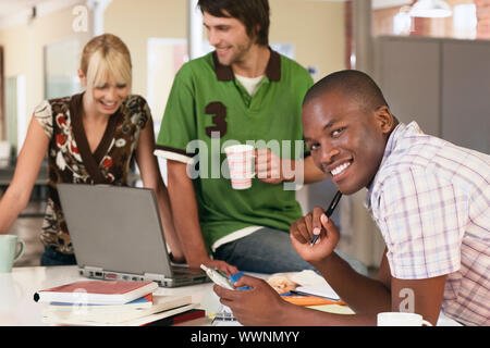 Smiling Man Holding Cell Phone Stock Photo