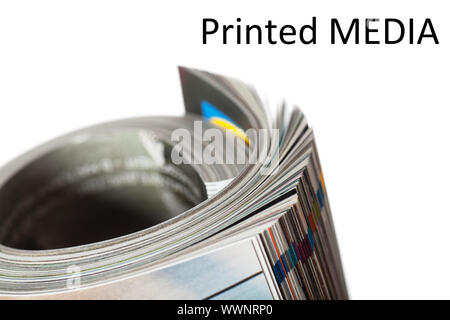 Closeup view of twisted magazine over white background Stock Photo