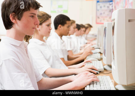 Students working on computer workstations Stock Photo