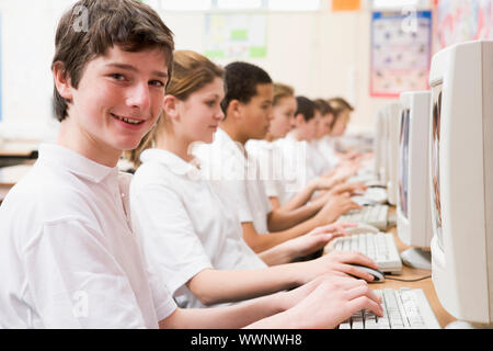 Students working on computer workstations Stock Photo