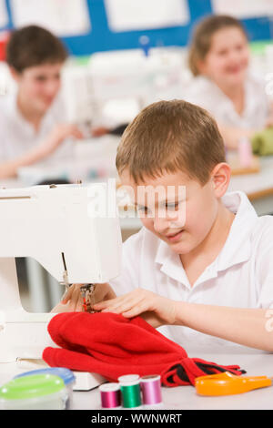 Male student using sewing machine Stock Photo