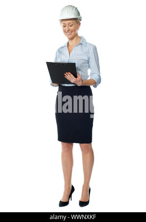 Elderly female architect posing in style as she look at her file Stock Photo