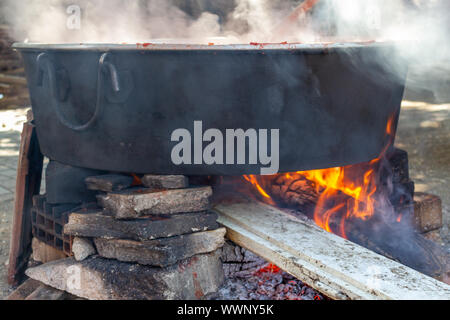 Cooking in a large boiler on a wood fire Stock Photo