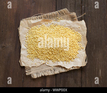 Raw millet on a craft paper with a word Millet Stock Photo - Alamy