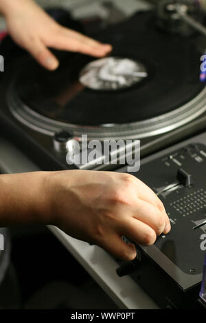 scratch battle of dj playing on his vinyls hand on Stock Photo