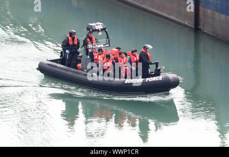 A group of people thought to be migrants are brought to shore by Border Force officers at the Port of Dover in Kent after a small boat incident in the Channel. Stock Photo