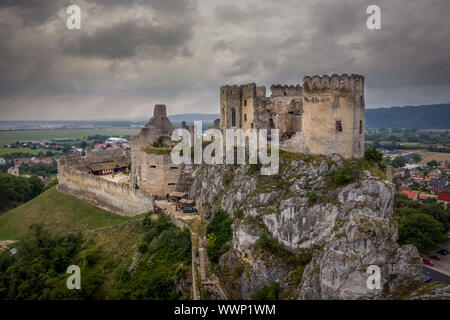 Aerial view of medieval ruined Beckov castle in Slovakia above the Vah river with Gothic chapel and stormy sky Stock Photo