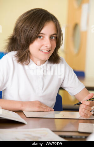 Student in class taking notes Stock Photo