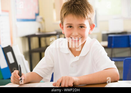 Student in class taking notes Stock Photo