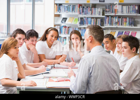 Students and teacher in a study group collaborating Stock Photo