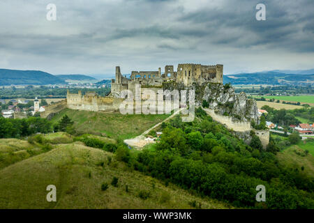 Aerial view of medieval ruined Beckov castle in Slovakia above the Vah river with Gothic chapel and stormy sky Stock Photo