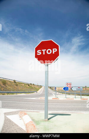 stop sign next to a cross on a spanish highway Stock Photo