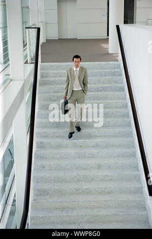 Man walking down stairs Stock Photo