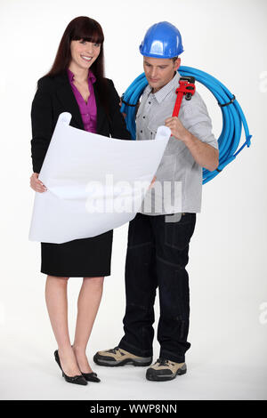 female architect and plumber discussing about works Stock Photo