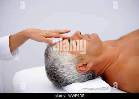 Mature man having facial massage Stock Photo