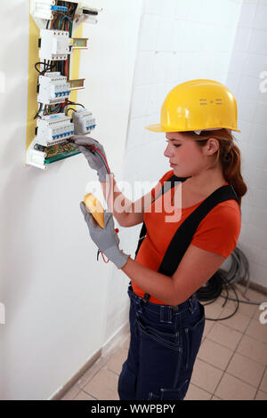 Female electrician with a fuse box Stock Photo