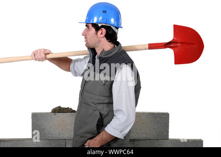 craftsman with shovel on his shoulder Stock Photo - Alamy