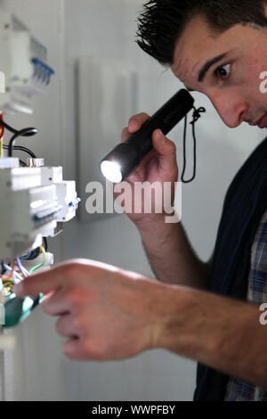 Portrait Of A Male Electrician Fixing Light On Ceiling Stock Photo - Alamy