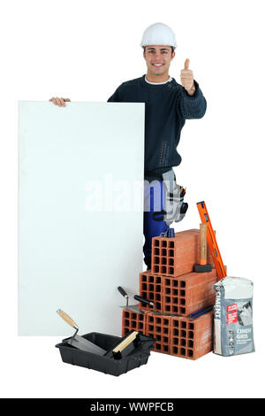 Thumbs up from a builder with a blank board Stock Photo
