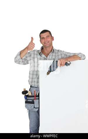 Thumbs up from a builder with a blank board Stock Photo