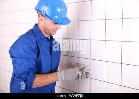 Worker fixing a switch Stock Photo