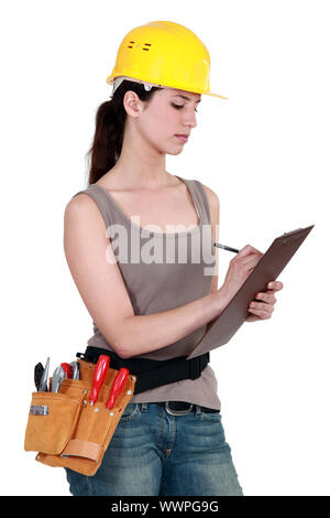 Female builder holding clipboard Stock Photo