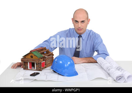 Architect sat at his desk Stock Photo