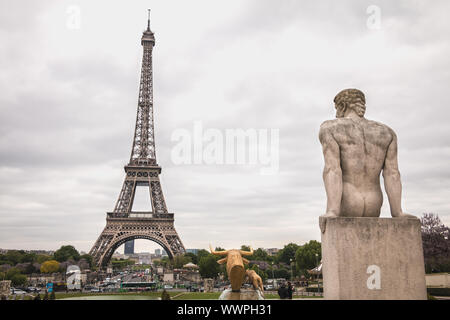 Paris, France - May 5, 2017: Statue of the Man, sculptor Pierre Traverse (1892-1979) located in the garden of Trocadero and looking at the Eiffel Towe Stock Photo