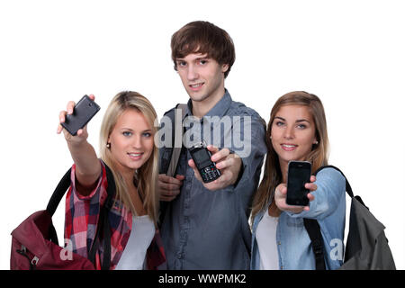 Teenagers showing mobile phones Stock Photo