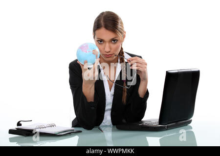 Office worker holding globe Stock Photo