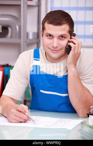 Technician on phone in office Stock Photo