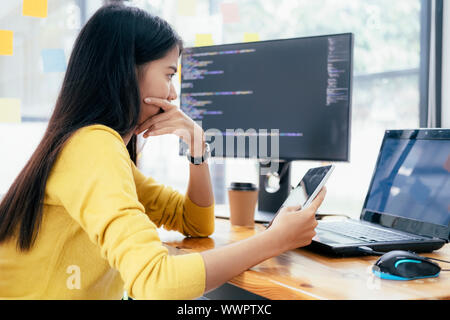 Programmers and developer teams are coding and developing software. Stock Photo