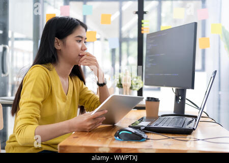 Programmers and developer teams are coding and developing software. Stock Photo