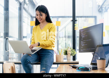 Programmers and developer teams are coding and developing software. Stock Photo