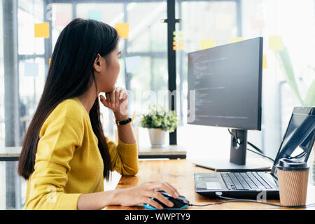 Programmers and developer teams are coding and developing software. Stock Photo