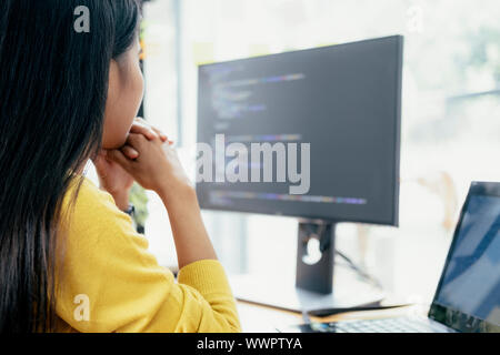 Programmers and developer teams are coding and developing software. Stock Photo