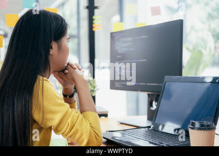 Programmers and developer teams are coding and developing software. Stock Photo