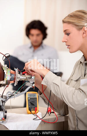 Woman repairing television Stock Photo